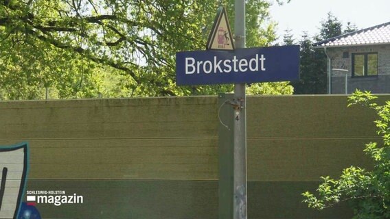 Ein Bahnhofsschild mit der Aufschrift "Brokstedt". © Screenshot 